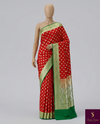Red silk, green borders, and timeless vibes.