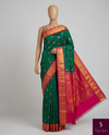 The Sovereign Emerald: Deep Green Kanchipuram Silk Saree with Fuchsia Pink & Gold Zari Border