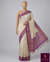 Elegant cream raw silk saree with a rich purple border for a regal touch. π€πβ¨