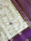 Elegant cream raw silk saree with a rich purple border for a regal touch. π€πβ¨