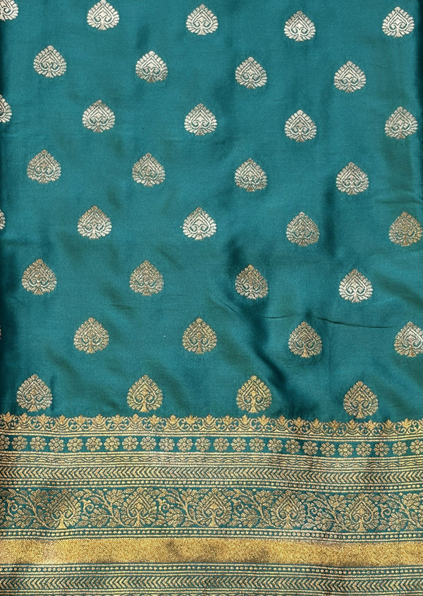 Stunning peacock blue saree with a rich gold border — bold, elegant, and timeless