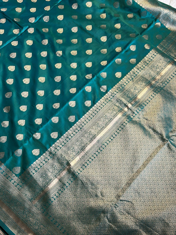 Stunning peacock blue saree with a rich gold border — bold, elegant, and timeless