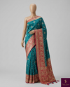The Empress Teal: Teal Blue Banarasi Katan Silk Saree with Crimson Shikargah Border & Swarovski Crystals