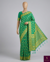 The Verdant Flow: Emerald Green Crepe Silk Saree with Gold Zari Buttas