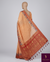 The Amber Ikat Temple: Warm Peach Tussar Linen Silk Saree with Crimson Zari Border