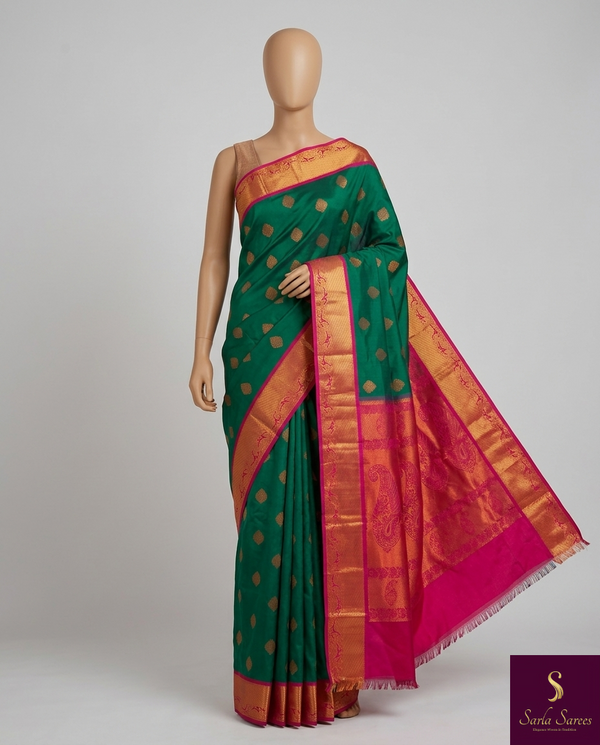 The Sovereign Emerald: Deep Green Kanchipuram Silk Saree with Fuchsia Pink & Gold Zari Border