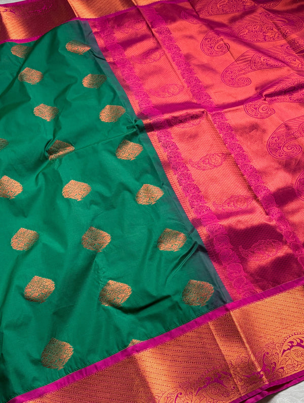 The Sovereign Emerald: Deep Green Kanchipuram Silk Saree with Fuchsia Pink & Gold Zari Border