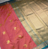 The Coral Mayil: Peach-Salmon Kanchipuram Silk Saree with Teal & Gold Zari Border