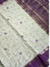Elegant cream raw silk saree with a rich purple border for a regal touch. 🤍💜✨