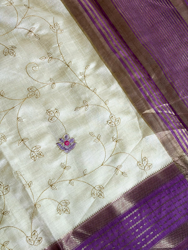 Elegant cream raw silk saree with a rich purple border for a regal touch. 🤍💜✨