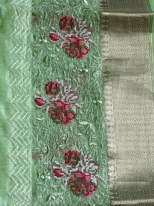 Fresh pista cotton saree with delicate cross-stitch embroidery for a subtle elegant touch. 💚✨