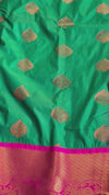 The Sovereign Emerald: Deep Green Kanchipuram Silk Saree with Fuchsia Pink & Gold Zari Border